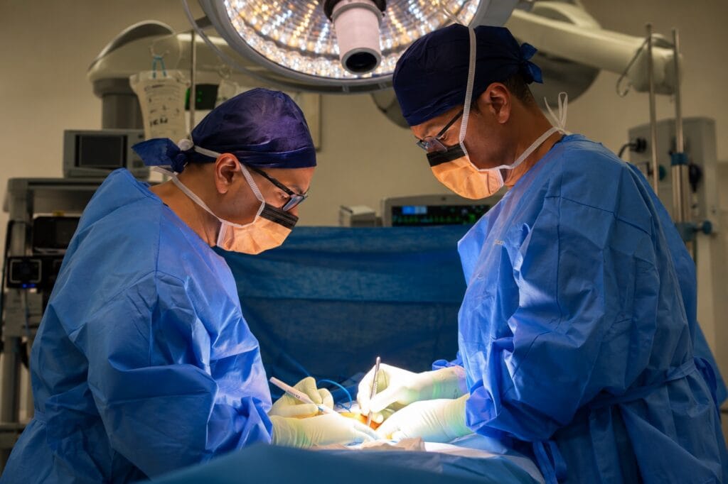 Two bariatric surgeons operating together in a hospital theatre